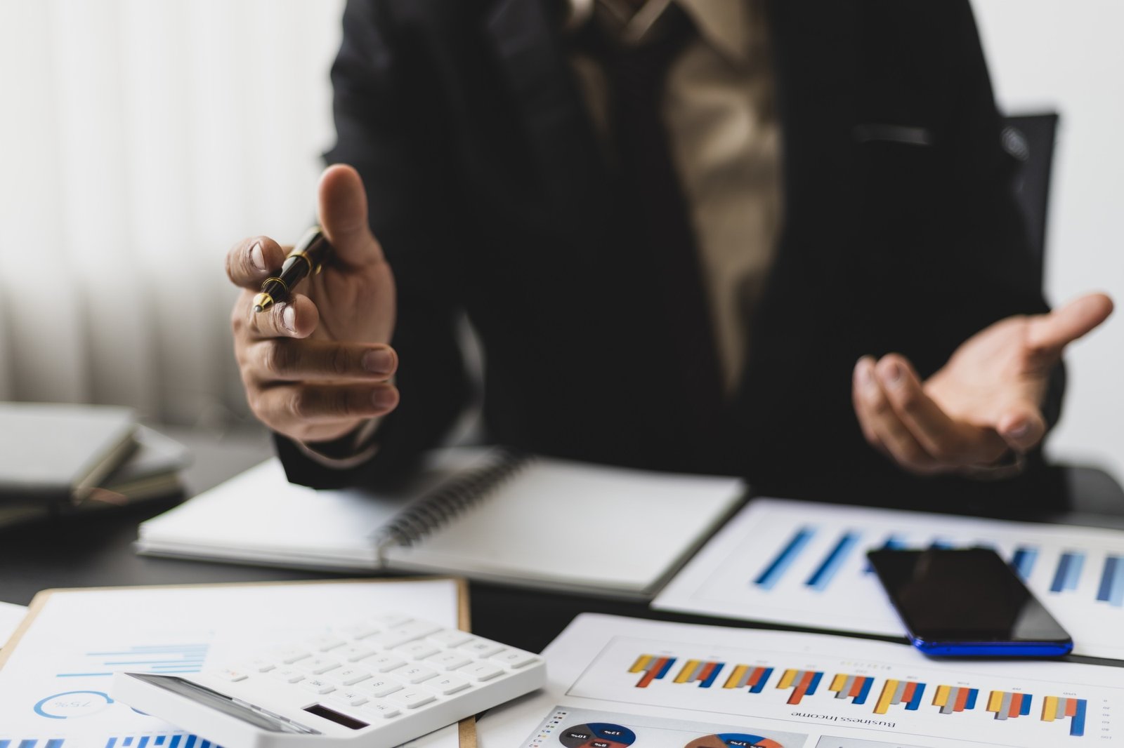 Businessman analyzes market statistical research reports and makes financial planning.